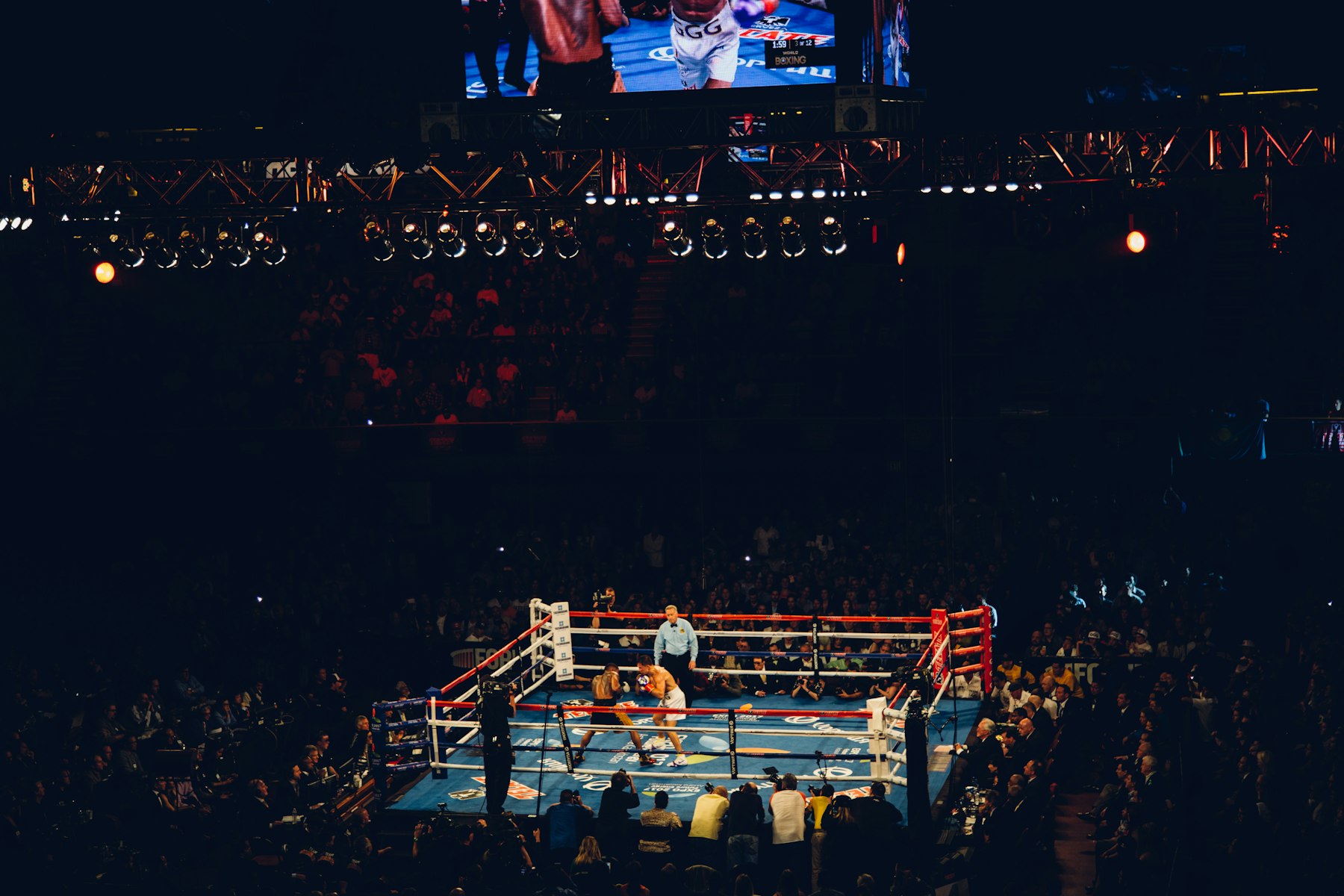 Boxing fighters facing off under arena lights